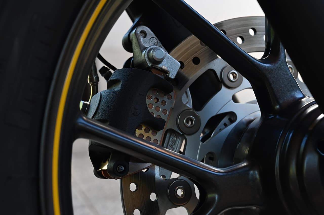 A brake disc and calliper, close up in low light